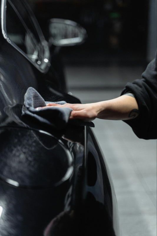 Person Wiping Car With Cloth